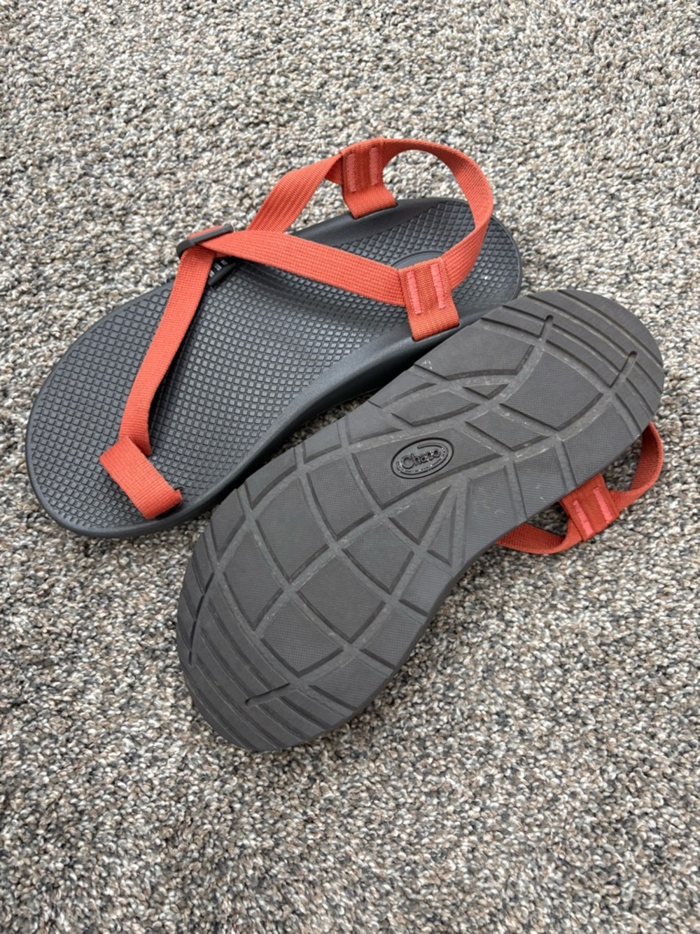 Chaco Bodhi sandals featuring orange straps and grey soles